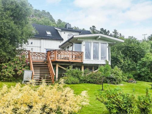 a large white house with a large deck at 11 person holiday home in kolvereid in Kolvereid