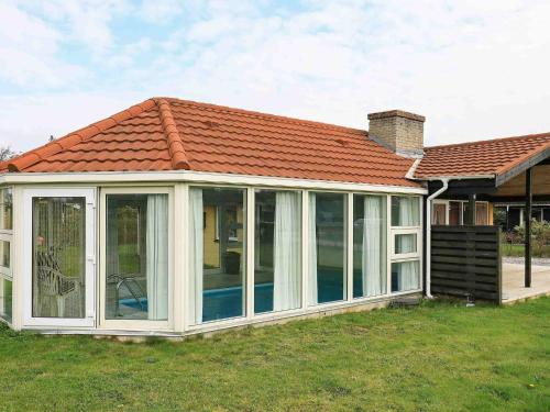 an apex conservatory with a red roof at 6 person holiday home in Ulfborg in Sønder Nissum