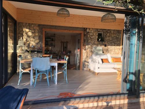 Il comprend un salon et une cuisine avec une table et des chaises. dans l'établissement Cabane de L Esteron, à Gilette