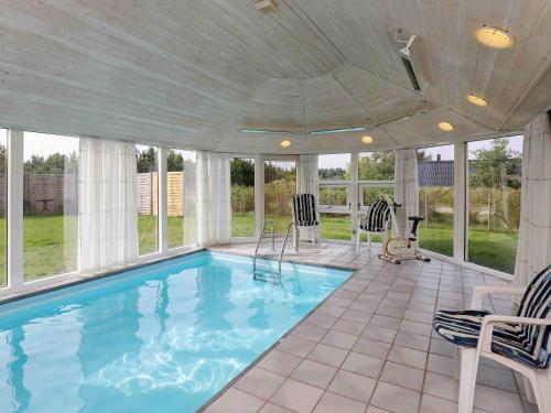 a swimming pool in a house with windows at 6 person holiday home in Ulfborg in Sønder Nissum