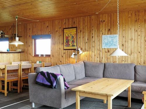 a living room with a couch and a table at 8 person holiday home in Harbo re in Harboør