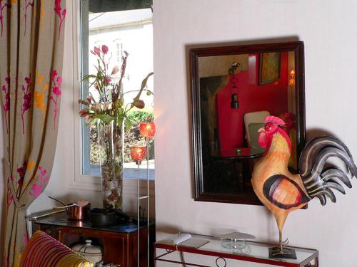 a room with a mirror and a chicken on a table at Logis Hotel Restaurant Nougier in Saint-Étienne-de-Fursac