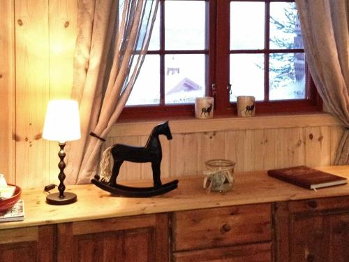 a table with a lamp and a horse statue on it at Five-Bedroom Holiday home in Trysil in Trysil