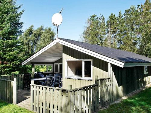 a small shed with a fence and chairs in it at 6 person holiday home in Fjerritslev in Fjerritslev