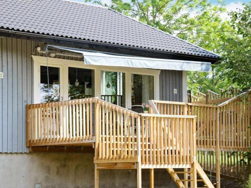 a home with a large wooden porch with a deck at 5 person holiday home in RYSSBY in Ryssby
