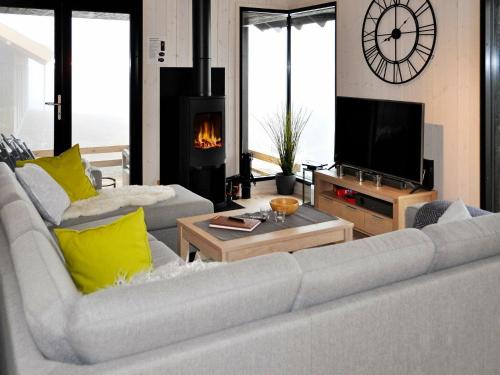 a living room with two white couches and a fireplace at 10 person holiday home in yer in Øyer