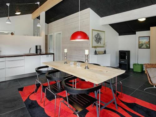 a kitchen with a wooden table and black chairs at 6 person holiday home in Strandby-By Traum in Strandby