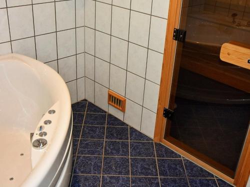 a bathroom with a tub and a sink and a shower at 6 person holiday home in Leikanger in Leikanger