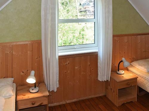 a bedroom with two beds and a window at 6 person holiday home in Leikanger in Leikanger