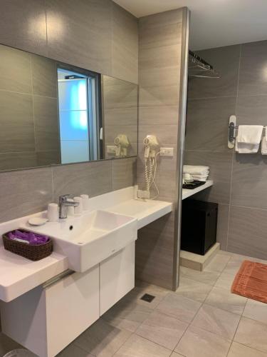 a bathroom with a sink and a mirror at Chi Shing Hai Hotel in Dahan