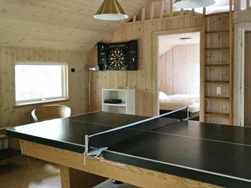 a ping pong table in a room with a living room at 12 person holiday home in R dby in Kramnitse