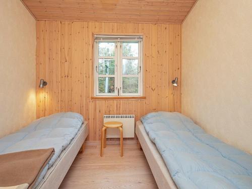 two beds in a room with a window at 6 person holiday home in Rødby-By Traum in Rødby