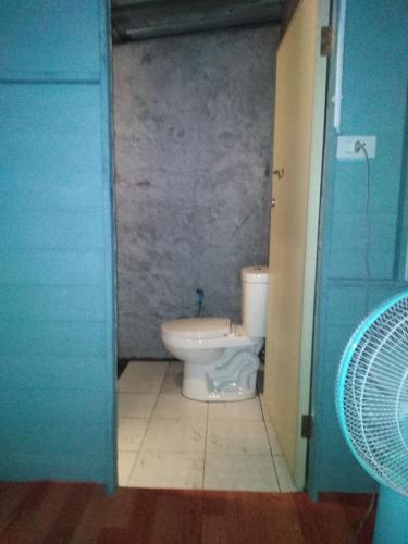 a bathroom with a toilet in a small room at Phayam Hostel in Ko Phayam