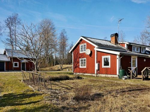 a red and white house in a field at 6 person holiday home in STOCKARYD in Stockaryd
