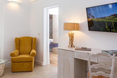 a living room with a desk and a chair at Palazzo Marini B&B di Charme in Lecce