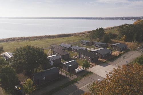 an aerial view of a row of houses by the water at Lodgepark Goitzsche GmbH in Große Mühle