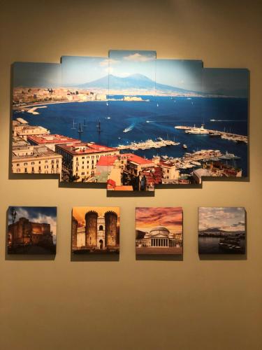 a group of pictures hanging on a wall at b&b don Mimì in Naples