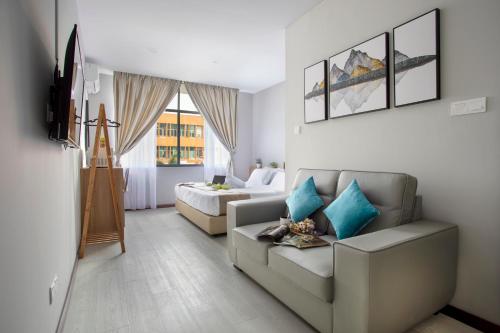 a living room with a couch and a bed at HotSpot @ City Centre by SSVC in Kota Kinabalu