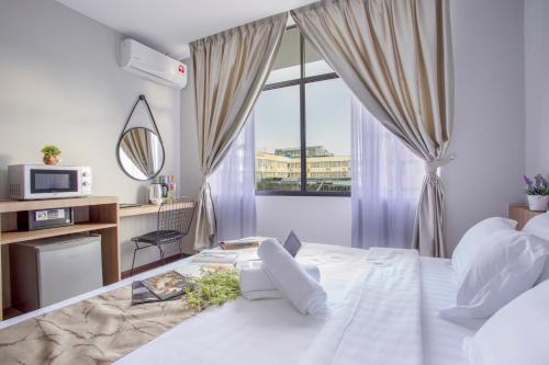 a bedroom with a large bed and a window at HotSpot @ City Centre by SSVC in Kota Kinabalu