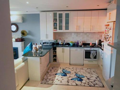 a kitchen with white cabinets and a island with a counter at Bektas Hill in Alanya