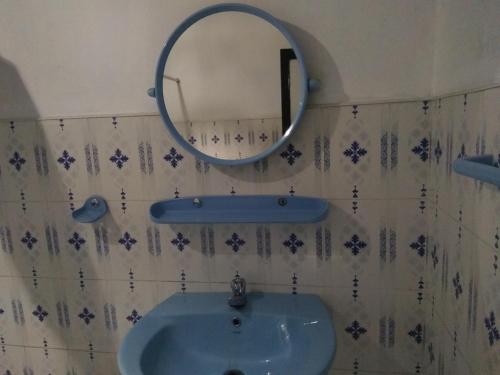 a bathroom with a sink and a mirror at Avon Field Holiday Bungalow in Nuwara Eliya