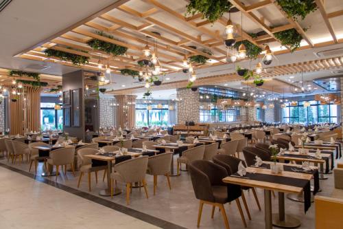 a large dining room with tables and chairs at Side Royal Style Hotel in Side