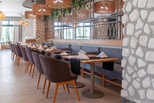 a row of tables and chairs in a restaurant at Side Royal Style Hotel in Side