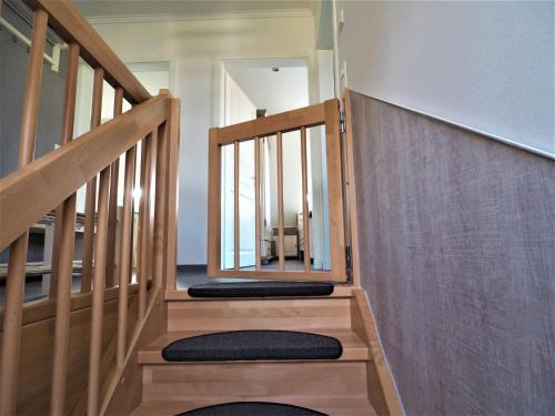 a stairway with a mirror on the wall at Freistehende Ferienwohnung in Rerik mit Sauna in Rerik