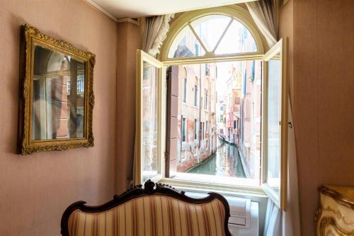 a window in a room with a bench in front at Apartment Rigoletto San Marco Square in Venice