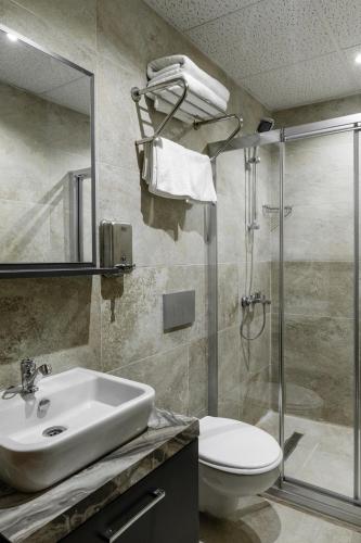 a bathroom with a sink and a shower and a toilet at madame roza in Istanbul