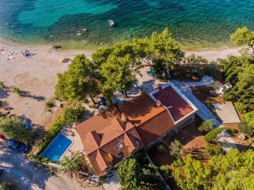 an overhead view of a house on a beach at Deluxe Villa Sirena on the beach with Pool in Supetar