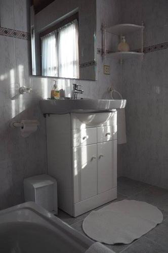 a bathroom with a sink and a tub and a toilet at El bordón de Noriega in Noriega