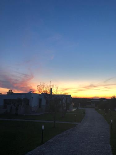 a sunset over a street in a city at Masseria Un Posto al Sole in Otranto