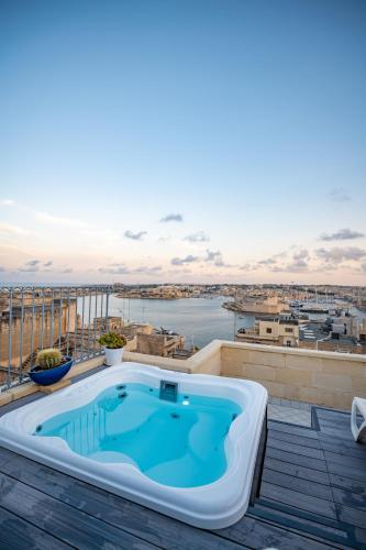 a hot tub on the roof of a house at Tano's Boutique Guesthouse in Valletta