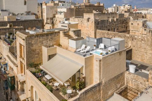 an aerial view of a building with a swimming pool at Tano's Boutique Guesthouse in Valletta