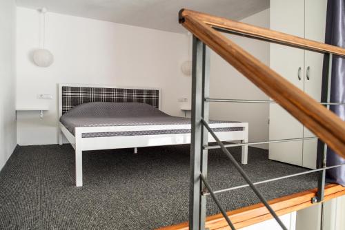 a small room with a bed and a staircase at Apartment Alja, Sara i Nevio jacuzzi in Dugi Rat