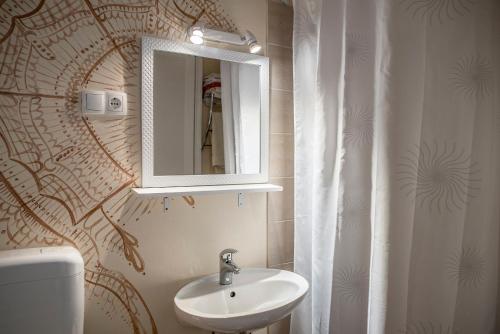a bathroom with a sink and a mirror and a toilet at Apartment Alja, Sara i Nevio jacuzzi in Dugi Rat
