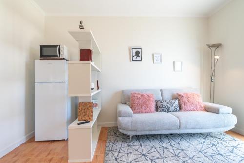 a living room with a couch and a shelf at Madeira House in Calheta