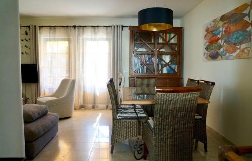a living room with a dining room table and chairs at Casa Mar e Serra in Cascais