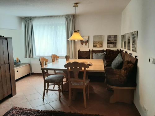 a living room with a table and a couch at Villa SKYLO in Winterberg