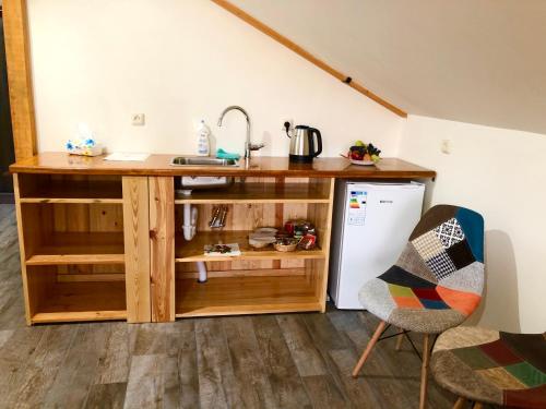 a kitchen with a counter and a sink and a chair at Green Stone Boutique Hotel in Yeghegnadzor