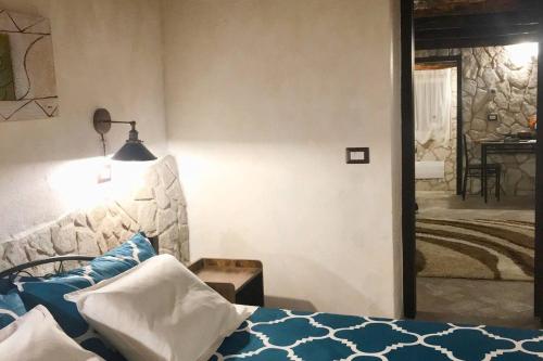 a bedroom with a bed with blue and white pillows at Casa Lisetta in Villa D'agri