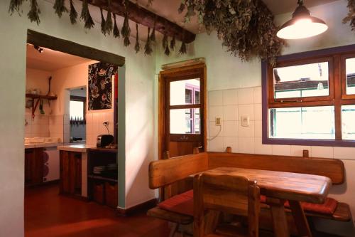 a dining room with a table and a kitchen at La Casona De Odile in El Bolsón