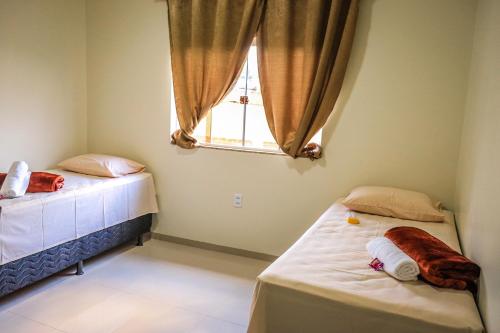 En eller flere senge i et værelse på Pousada Casa Grande