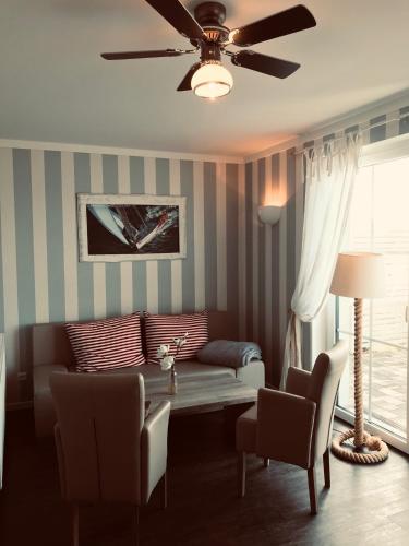 a living room with a couch and a table at Der LeuchtTurm-Gastro GmbH in Geierswalde