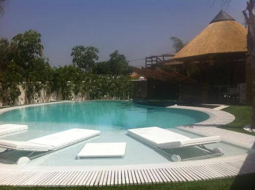 a swimming pool with lounge chairs and a gazebo at Villa Campito in El Puerto de Santa María