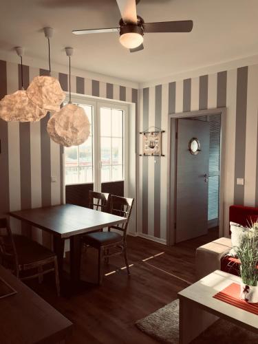 a living room with a table and a couch at Der LeuchtTurm-Gastro GmbH in Geierswalde