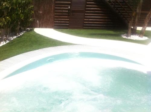 a swimming pool in a yard with a lawn at Villa Campito in El Puerto de Santa María