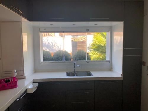 a kitchen with a sink and a window at Villa Campito in El Puerto de Santa María