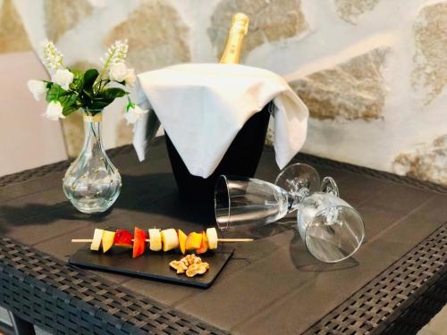 a table with a plate of food and a vase at Canaryislandshost l Nazaret Suites in Nazaret